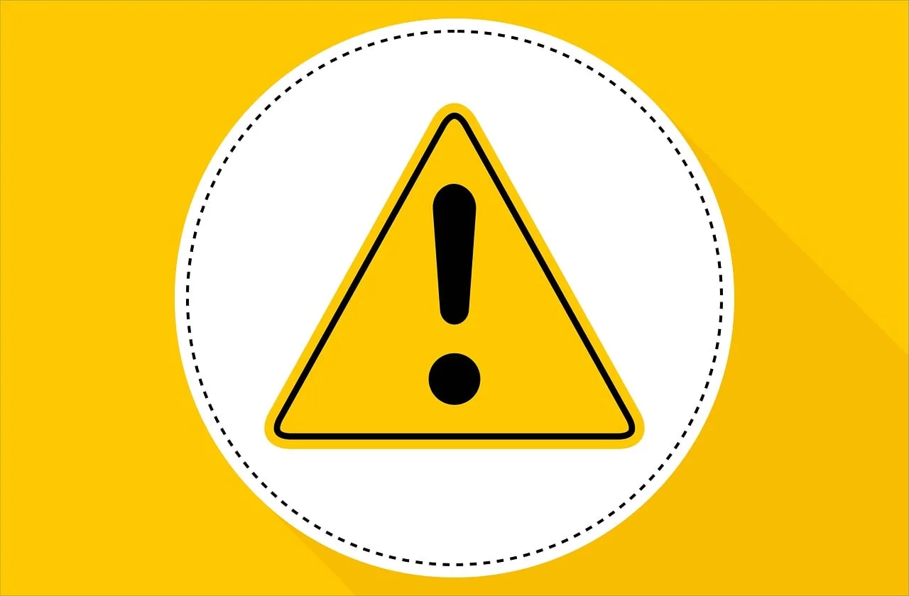 Yellow warning triangle with a black exclamation mark on a yellow and white graphic background.
