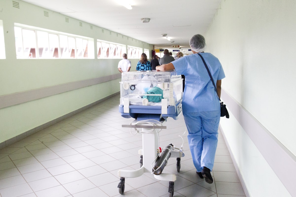 person walking on hallway in blue scrub suit