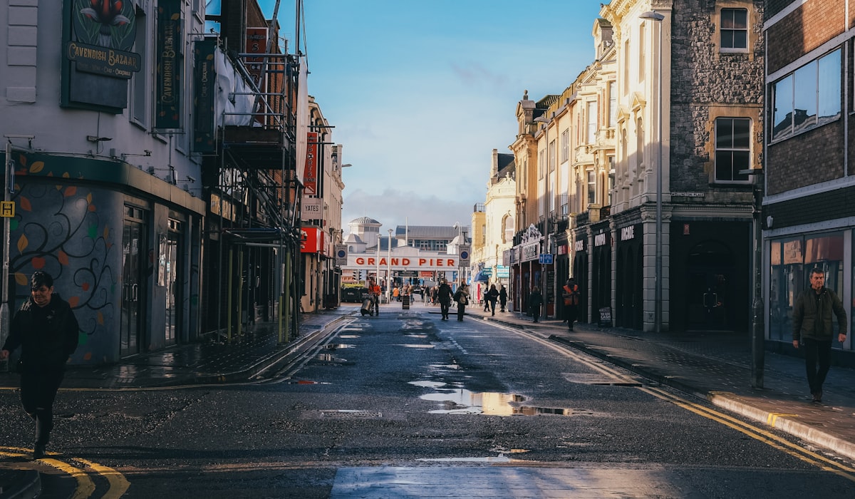 a city street with people walking down it